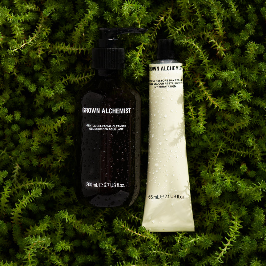 Grown Alchemist skincare products on a green leafy background