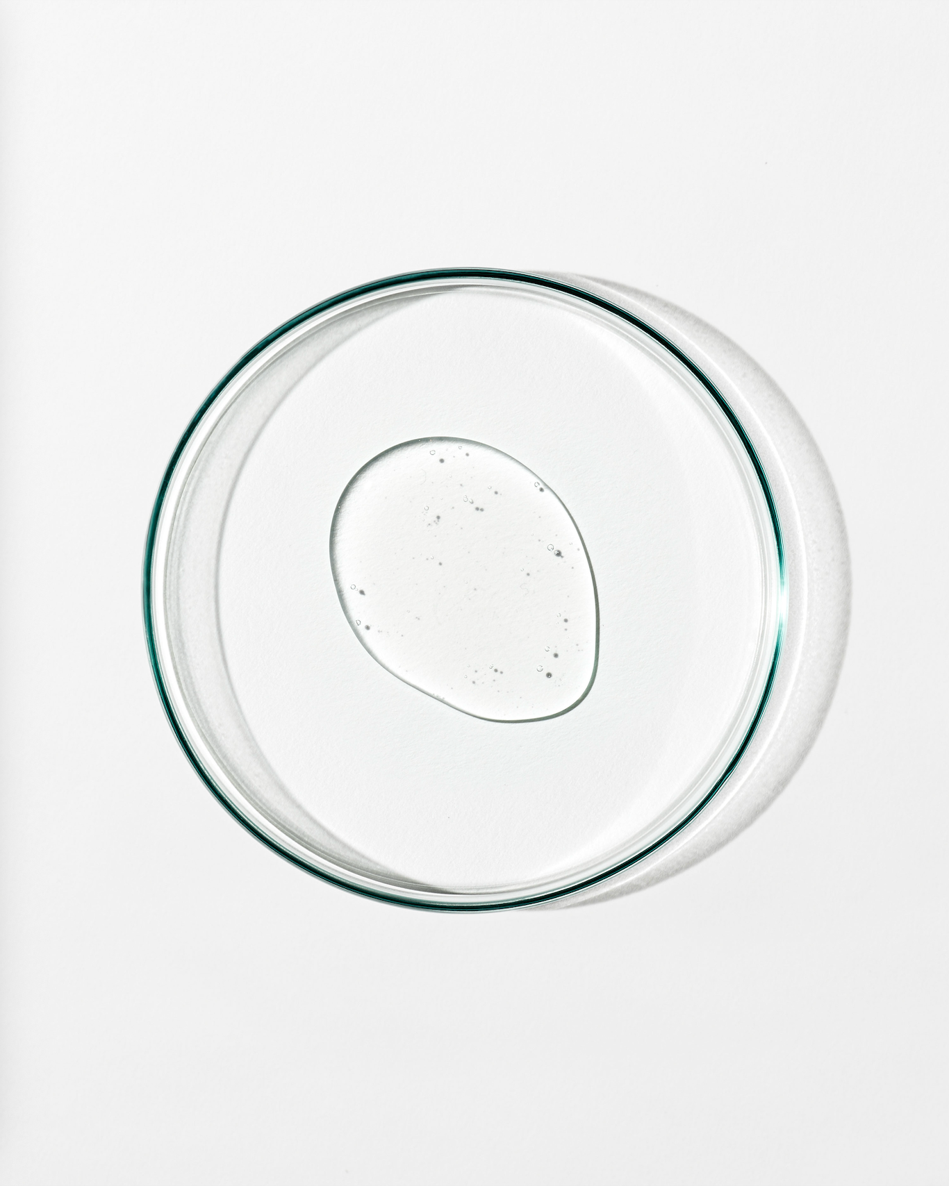 Clear dish whit clear liquid against a white background