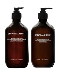 Two bottles of Grown Alchemist hand wash and cream on a white background