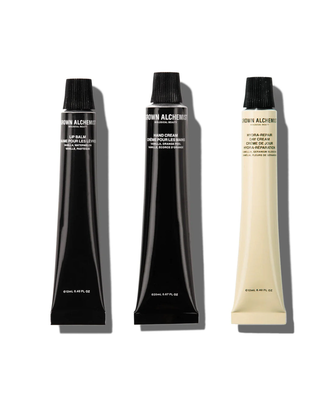 Three tubes of Grown Alchemist cream on a white background