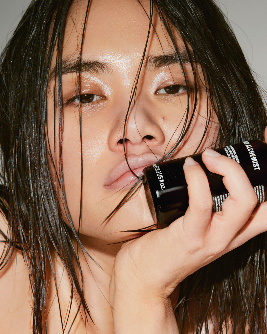 Person holding a cosmetic product with a blurred background