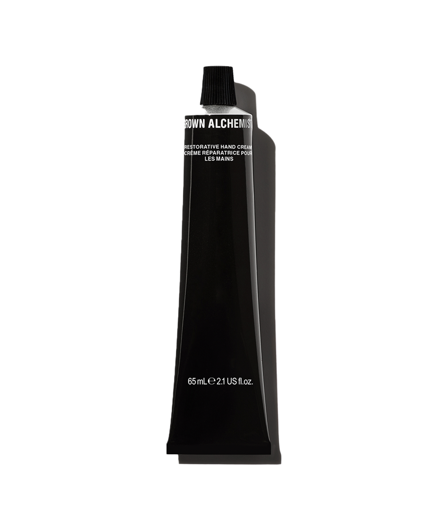 A black bottle of Restorative Hand Cream by Grown Alchemist with white and silver text indicating the product size of 65mL.