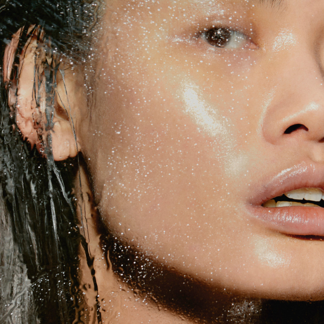 Close-up of a person's face with water droplets on skin