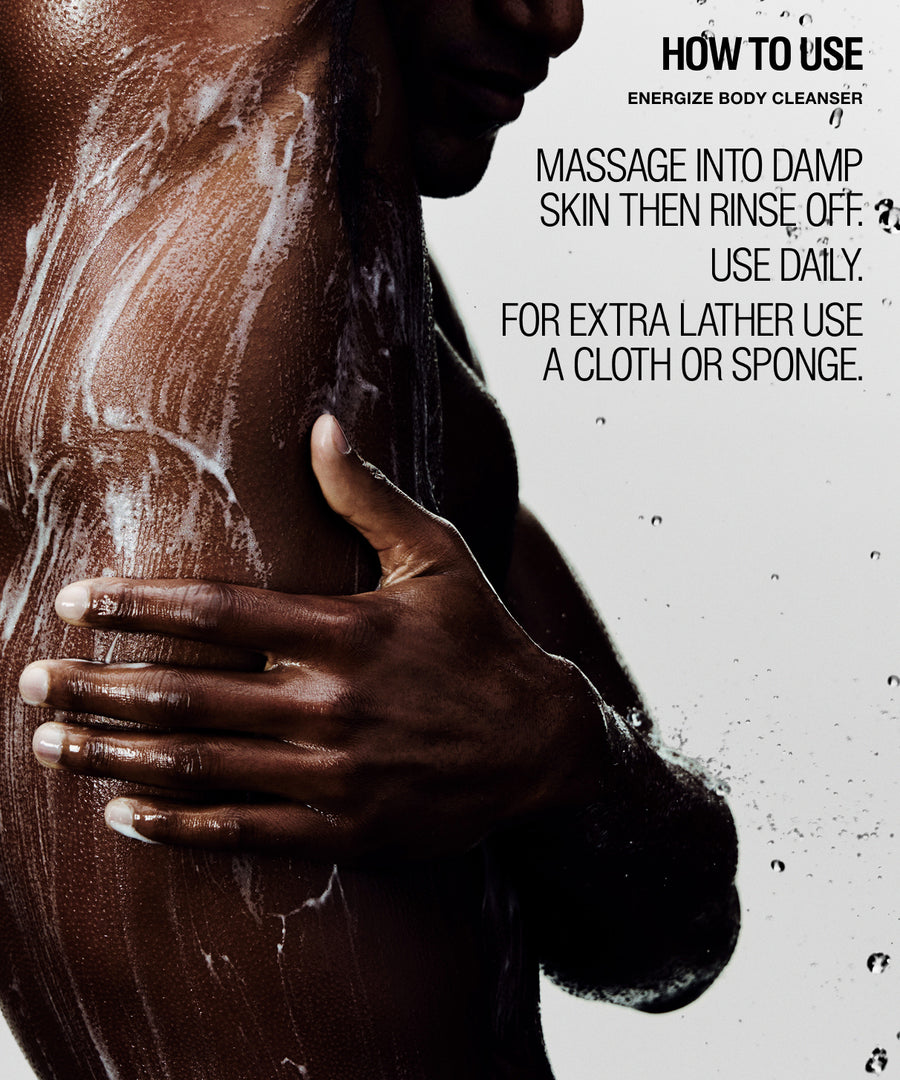 A close-up of a person's upper torso and hand while applying a foamy body cleanser, with text on the right reading 'HOW TO USE ENERGIZE BODY CLEANSER' and usage instructions.
