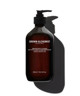 A 500ml pump bottle of Grown Alchemist Enriched Body Cleanser, made of dark amber-brown translucent plastic with a black pump dispenser. The bottle is centered against a clean white background, casting a prominent dark shadow to the right.