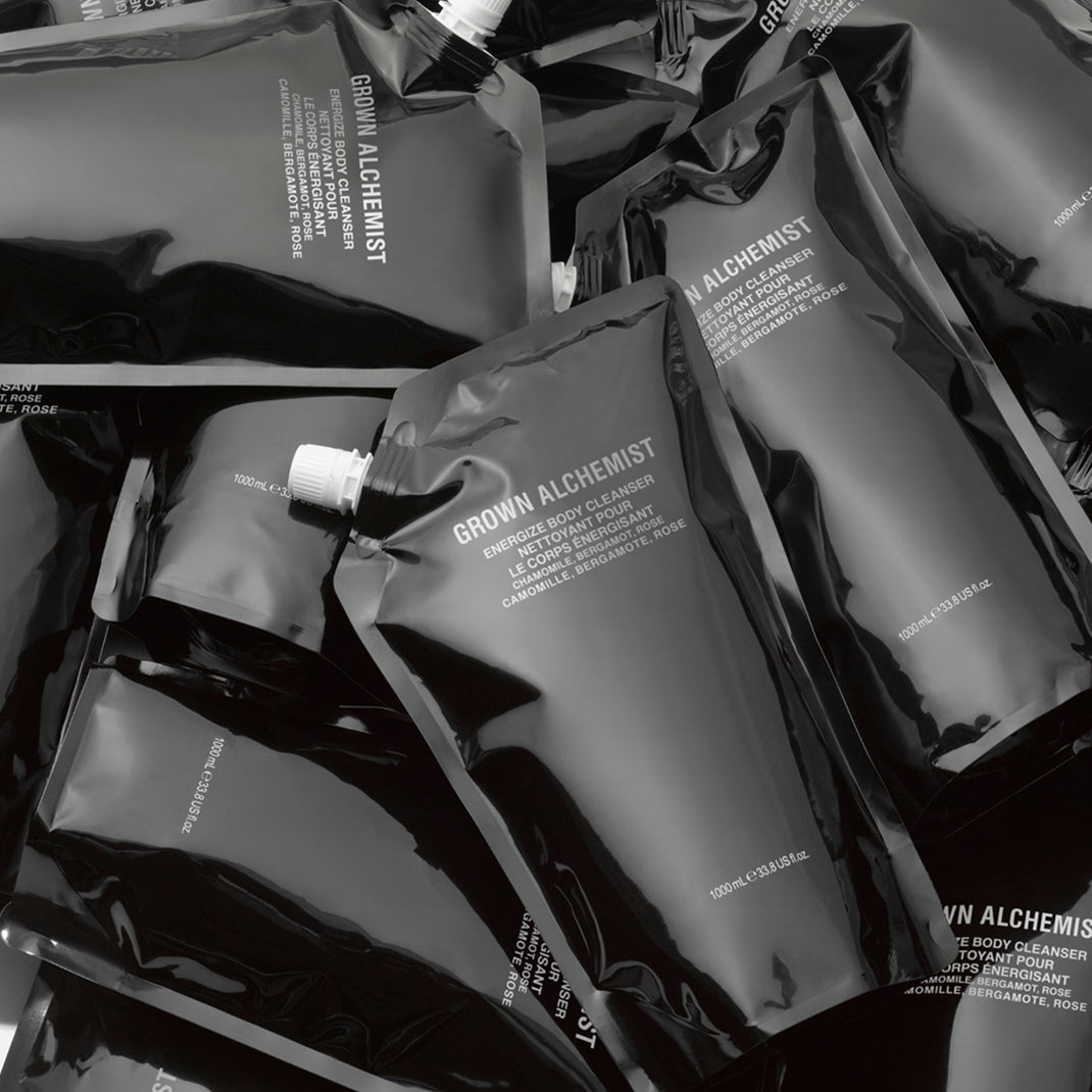 Black pouches with 'Grown Alchemist' branding on a white background