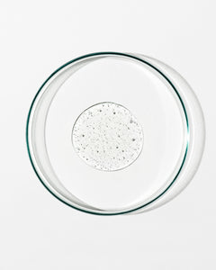 Clear glass pie dish with clear liquid on a white background
