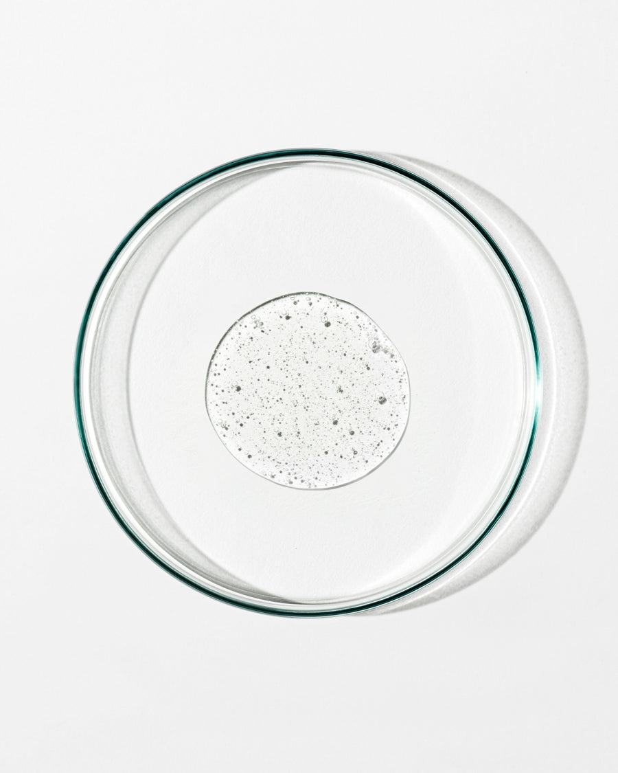 Clear glass pie dish with clear liquid on a white background