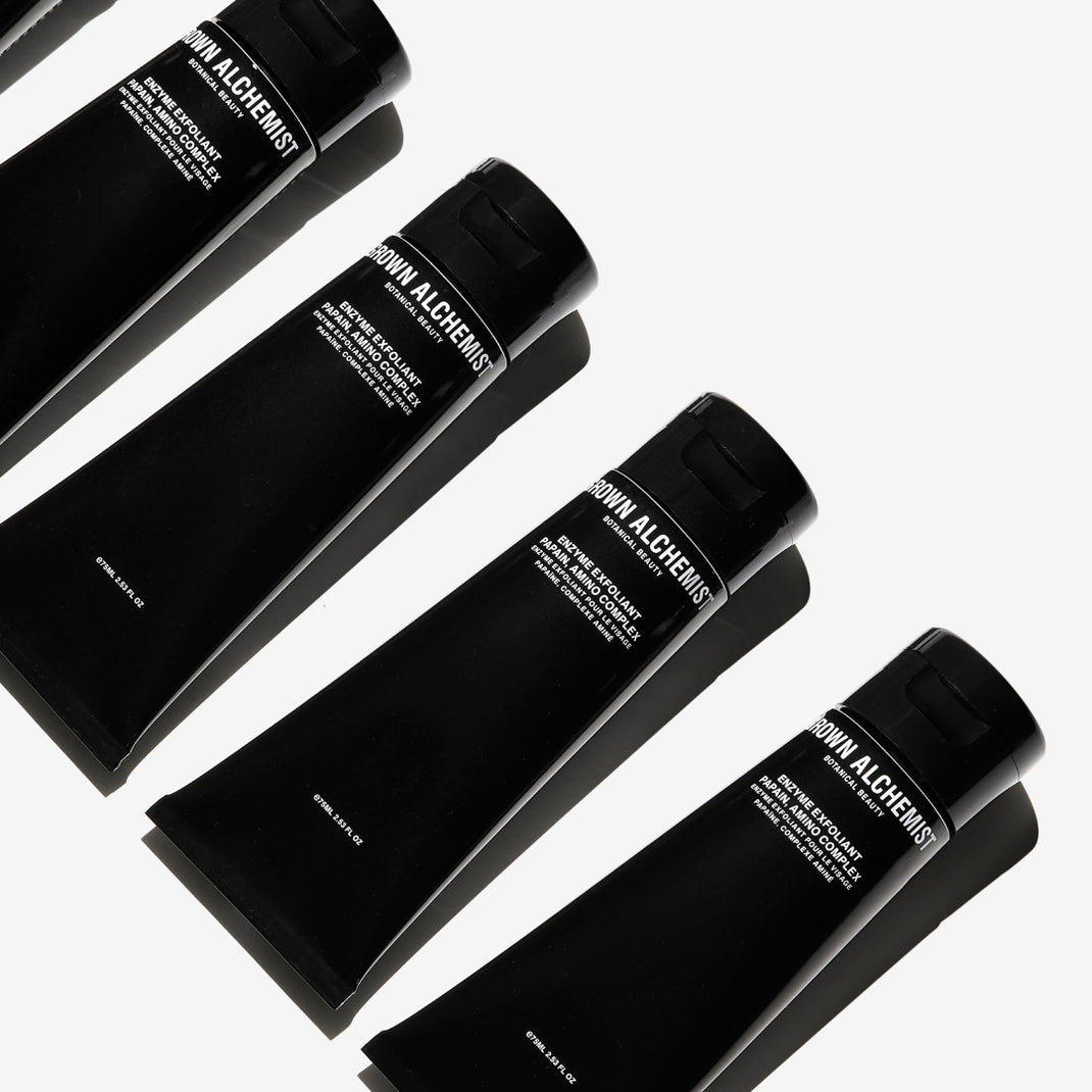 Four tubes of Enzyme Exfoliator on a white background