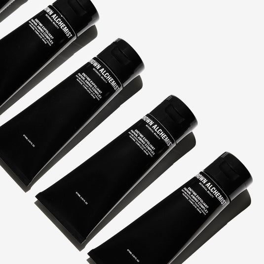 Four tubes of Enzyme Exfoliator on a white background