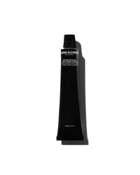 Black cosmetic tube with brand name on a white background