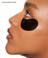 Close-up side profile of a person wearing a black oval eye patch under the eye, with the text 'HYDRA-RESTORE EYE PATCHES' in the top left corner on a white background.