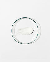 Swatch of regenerating moisturizer on white background.