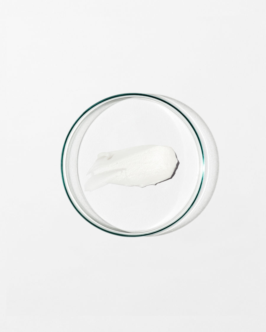 Swatch of regenerating moisturizer on white background.