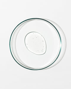 Clear glass pie dish with a dollop of gentle gel facial cleanser on a white background