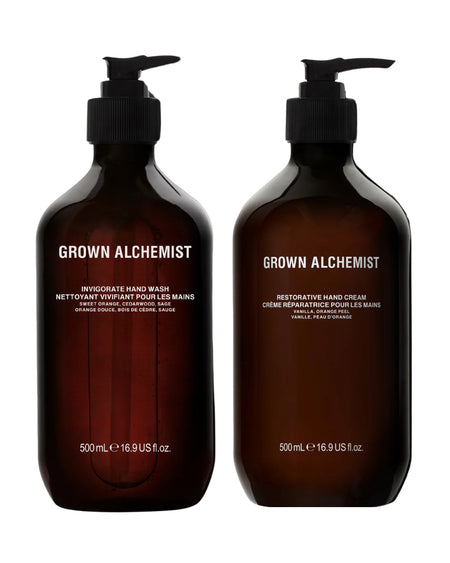 Two bottles of Grown Alchemist hand wash and cream on a white background