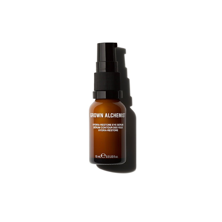 A bottle of Hydra-Restore Eye Serum with a black pump dispenser, labeled with the brand Grown Alchemist.