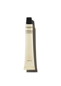 A travel size tube of Hydra-Restore Day Cream with a white and beige label, predominantly beige stick packaging.