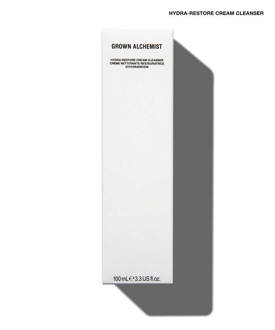 A tall, slim white rectangular box for Grown Alchemist Hydra-Restore Cream Cleanser, shown on a white background with a soft gray shadow to the right.