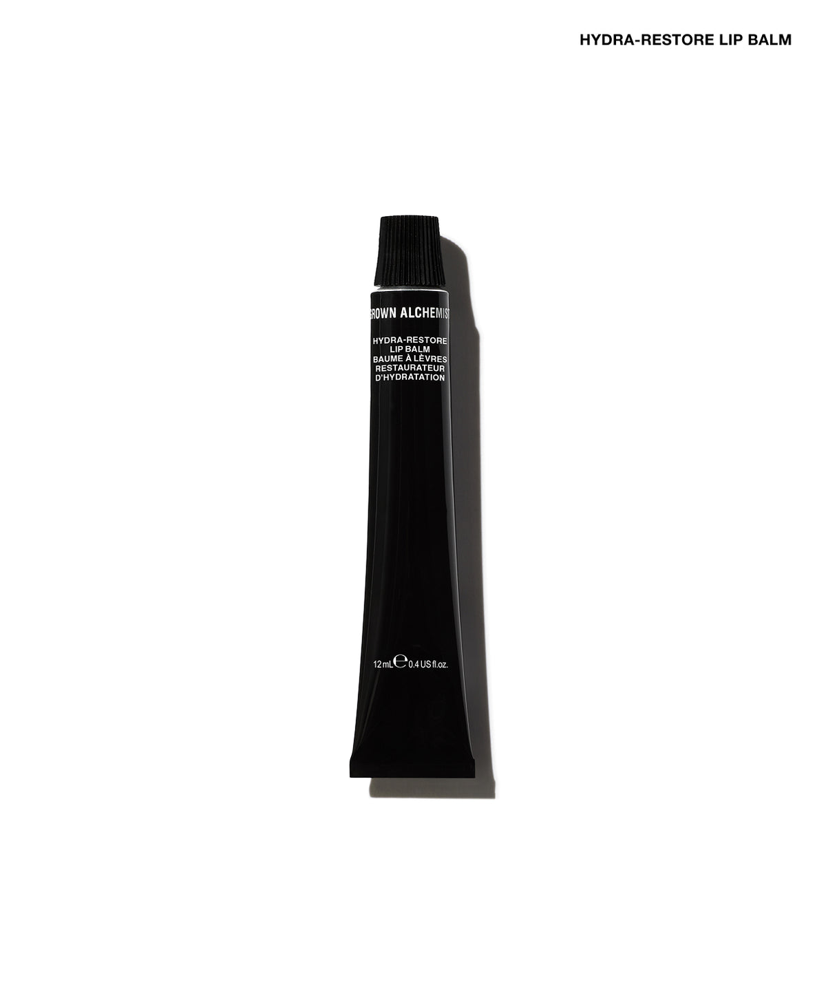 A single black cosmetic tube of Hydra-Restore Lip Balm, shown vertically against a plain white background with a soft shadow.