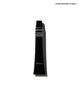 A single black cosmetic tube of Hydra-Restore Lip Balm, shown vertically against a plain white background with a soft shadow.