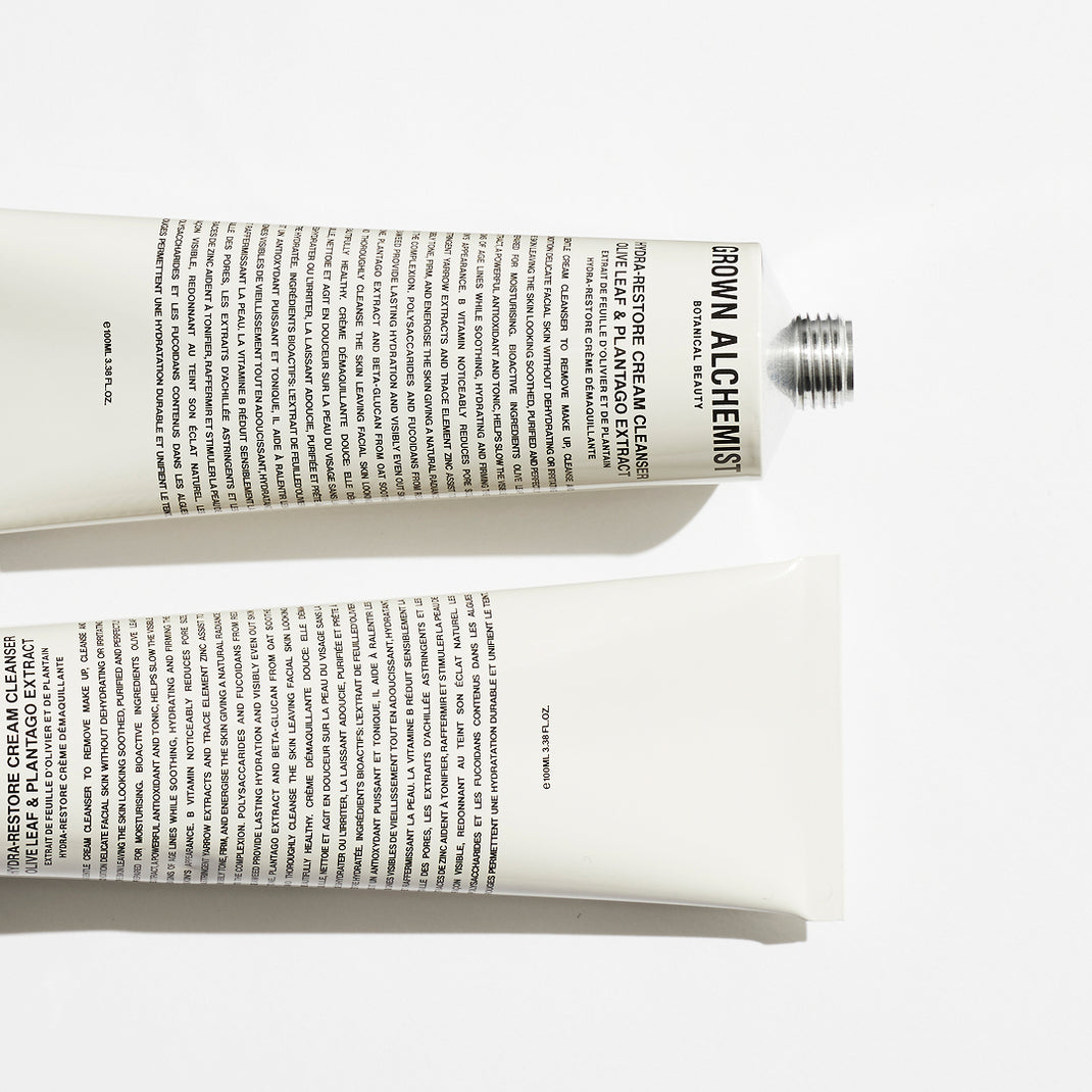 Two tubes of Brown Alchemists skincare product on a white background