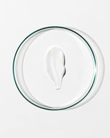 White cream in a clear glass bowl on a white background