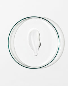 White cream in a clear glass bowl on a white background