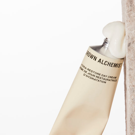 Hand cream tube with visible brand name on a light background