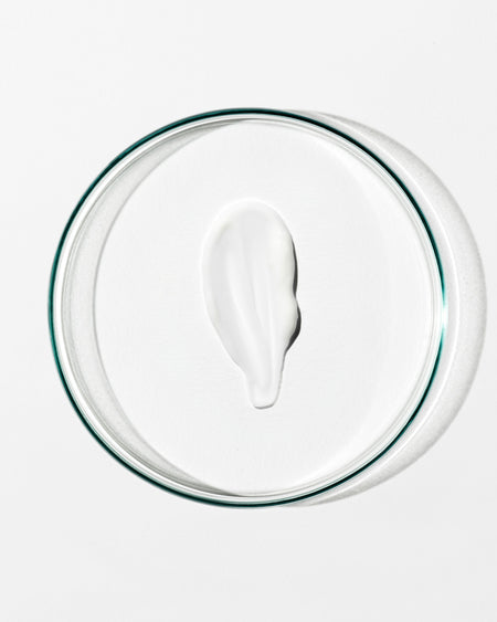 White cream on a clear glass plate with a white background