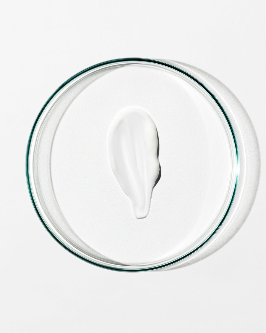 White cream on a clear glass plate with a white background