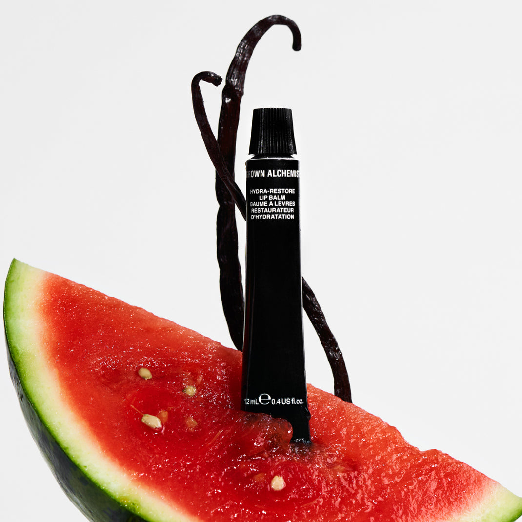 Black lip balm on a slice of watermelon with a white background