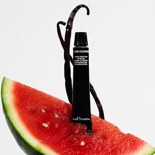 Black lip balm on a slice of watermelon with a white background