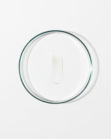 Clear glass lid with lip balm on white background.
