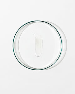 Clear glass lid with lip balm on white background.