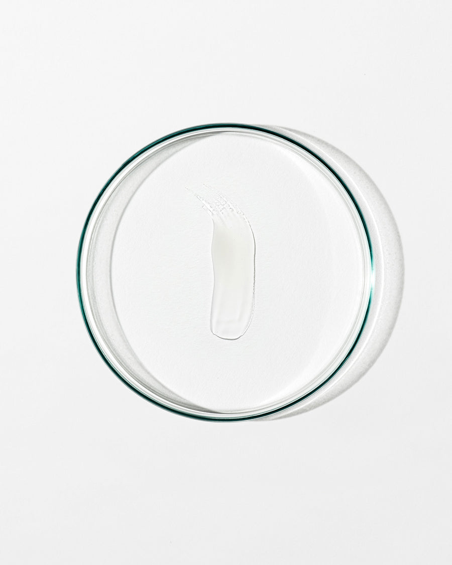 Clear glass lid with lip balm on white background.