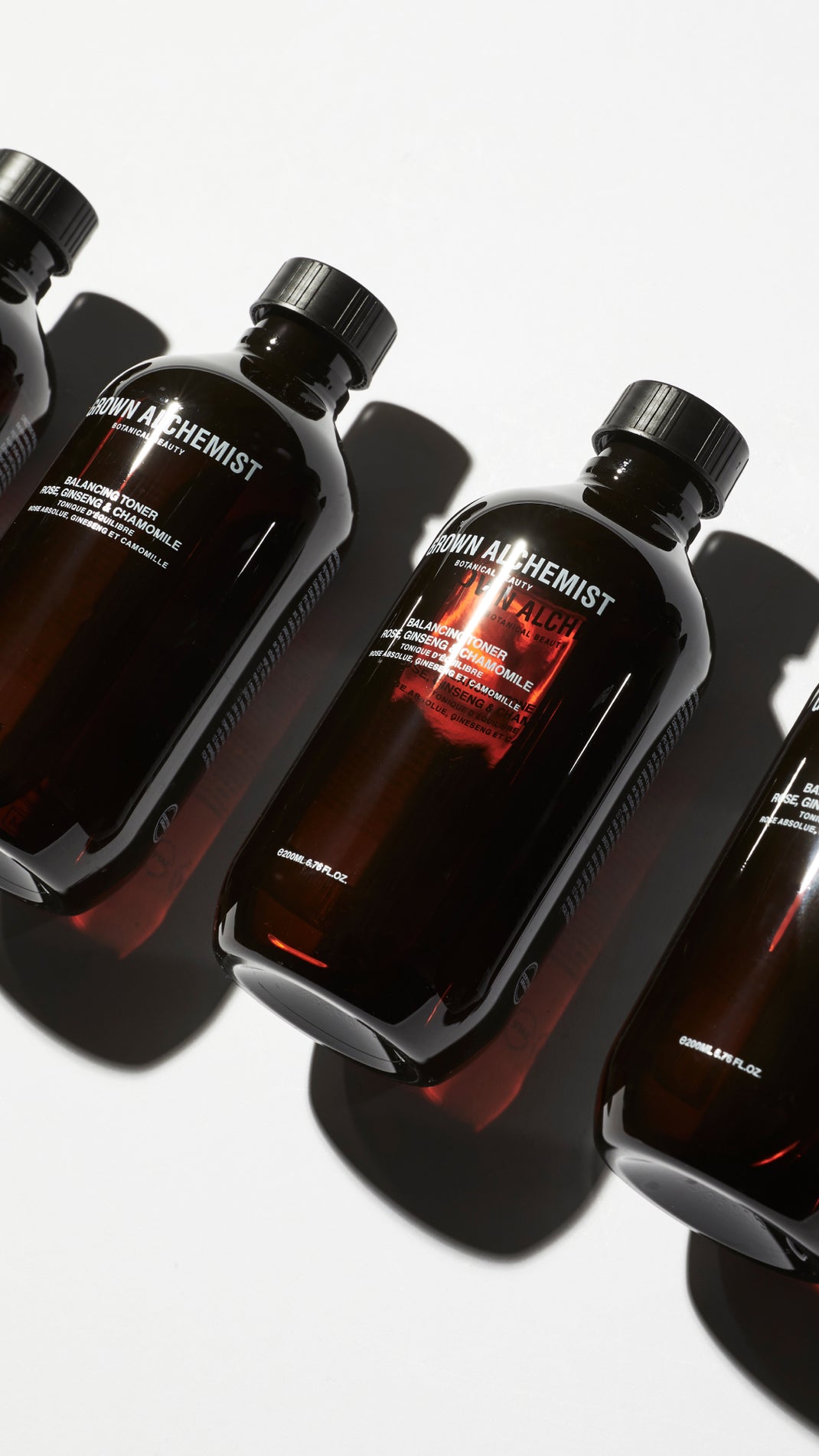 Three bottles of Grown Alchemist Balancing Toner on a white background