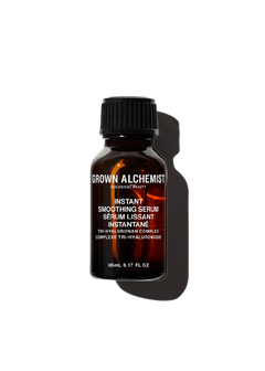 A bottle of Grown Alchemist Instant Smoothing Serum with a dark label and a clear, amber liquid visible inside.