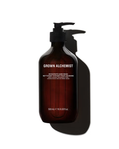 Brown bottle of Grown Alchemist hand wash on a white background