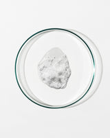 Clear glass bowl with a white foamy substance on a white background