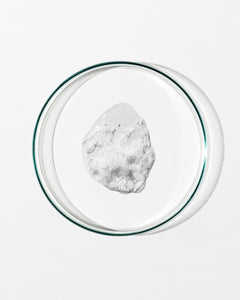 Clear glass bowl with a white substance on a white background