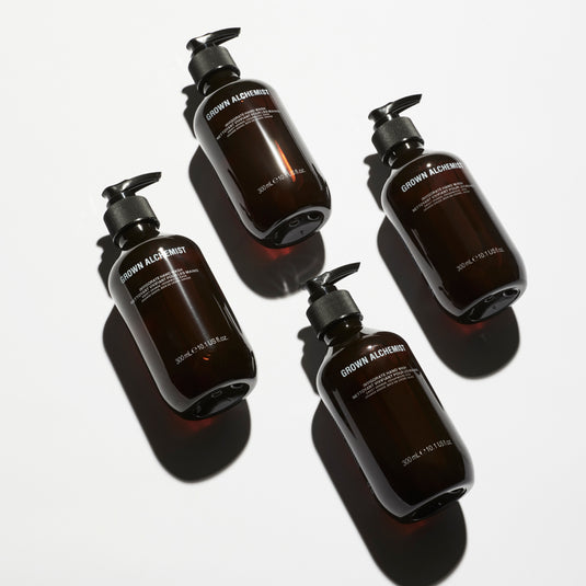 Four bottles of Grown Alchemist products on a white background
