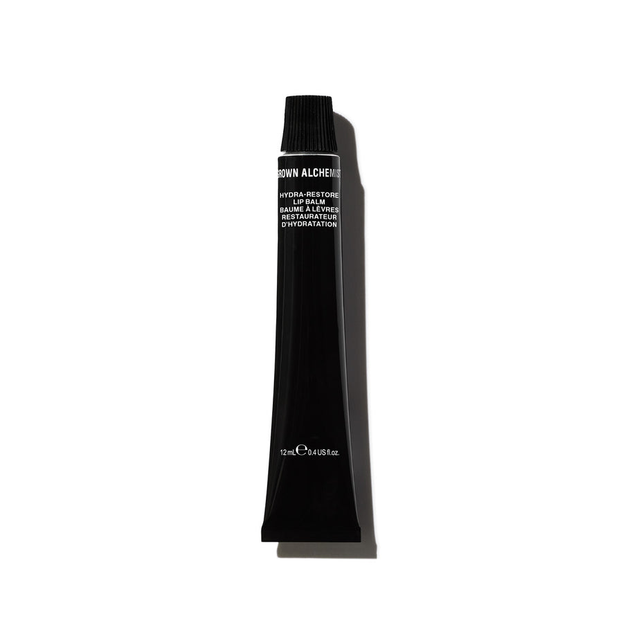 A black tube of Hydra-Restore Lip Balm by Grown Alchemist on white background.