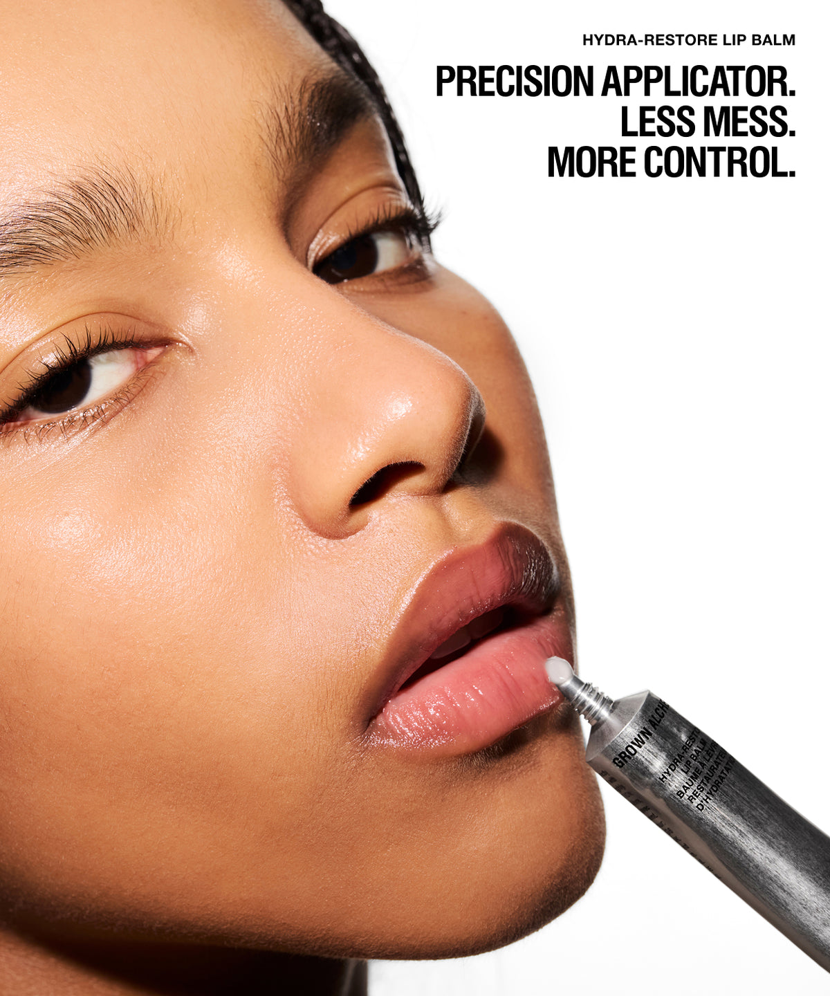 Close-up of a person applying lip balm from a precision tube to their lips, with text reading 'PRECISION APPLICATOR. LESS MESS.