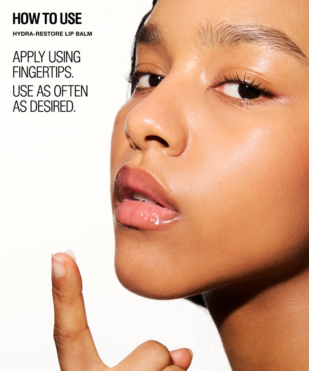Close-up beauty shot of a woman's face with text on the left reading 'HOW TO USE HYDRA-RESTORE LIP BALM APPLY USING FINGERTIPS. USE AS OFTEN AS DESIRED.