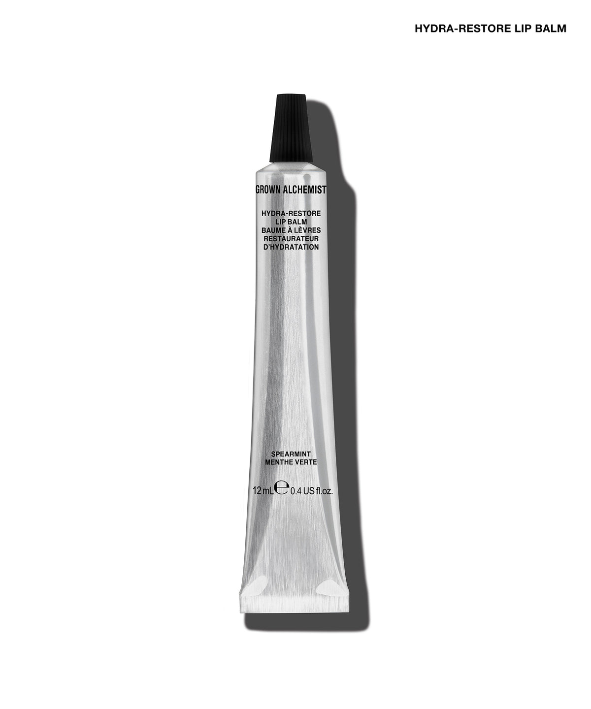 A single tube of GROW ALCHEMY Hydra-Restore Lip Balm on a clean white background with a soft shadow. The tube is metallic silver with a black cap, and the text 'HYDRA-RESTORE LIP BALM' is printed at the top right.