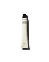Tube of Grown Alchemist lotion on a white background