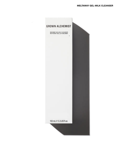 A tall, narrow white box for Grown Alchemist Meltaway Gel-Milk Cleanser, shown on a white background with a strong dark shadow to the right. The box has black text and is photographed from a top-down angle.