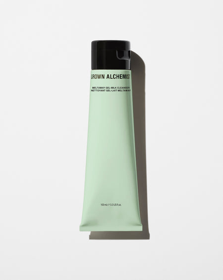 Green tube of Grown Alchemist product on a white background