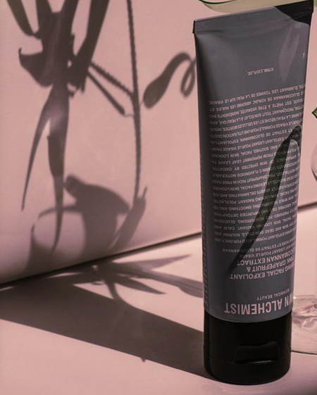 Tube of Grown Alchemist cream against a oink background